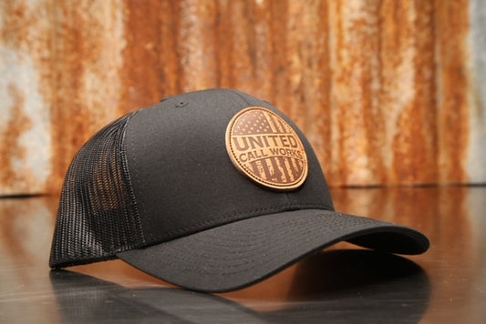 Black Yupoong Trucker Hat with leather Merica Patch